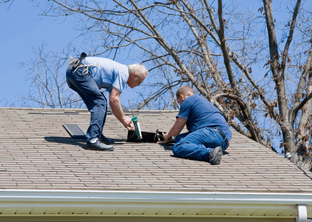 Two old man on top of a roof more like fixing it